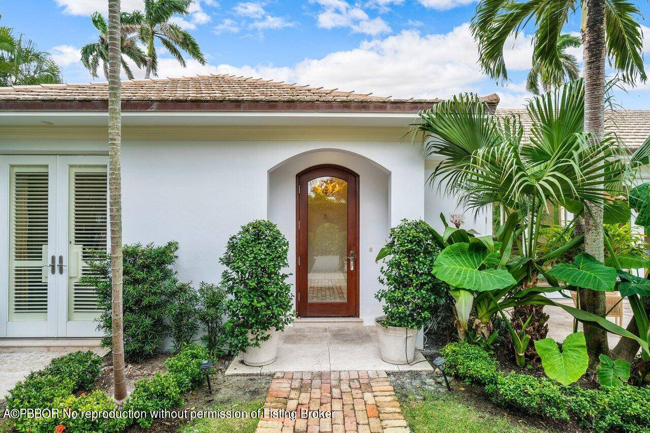 This bright, updated Bermuda style 4 bed and 4 bath home captures the charm of Palm Beach with the coveted privacy of being on the golf course.
