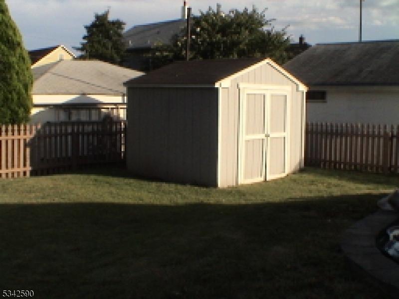 Fenced in back yard with shed