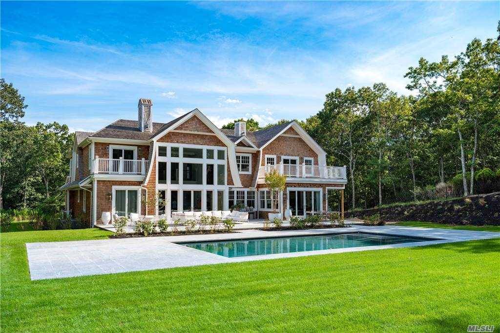 This 9, 500 square foot manse sits atop a beautifully elevated 2 acres in coveted Sag Harbor with 7 bedrooms, 8.