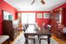Dining room with light wood-style flooring, a wall unit AC, a ceiling fan, and crown molding