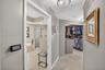 Custom walk in primary closet w/ secondary custom closet behind doors