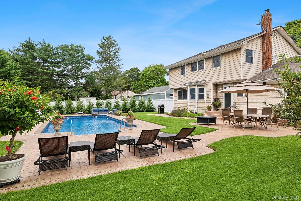 View of swimming pool featuring a patio area, a fenced backyard, and area for grilling