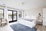 Bedroom with access to outside and light wood-style floors