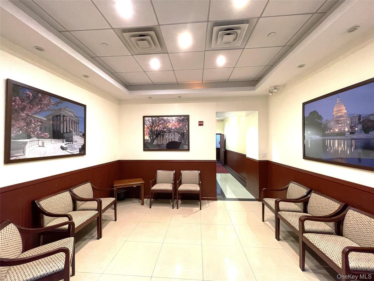 Lobby featuring wainscoting, wooden walls, and a drop ceiling