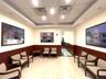 Lobby featuring wainscoting, wooden walls, and a drop ceiling