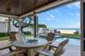 Covered patio pool deck with firepit and seating area