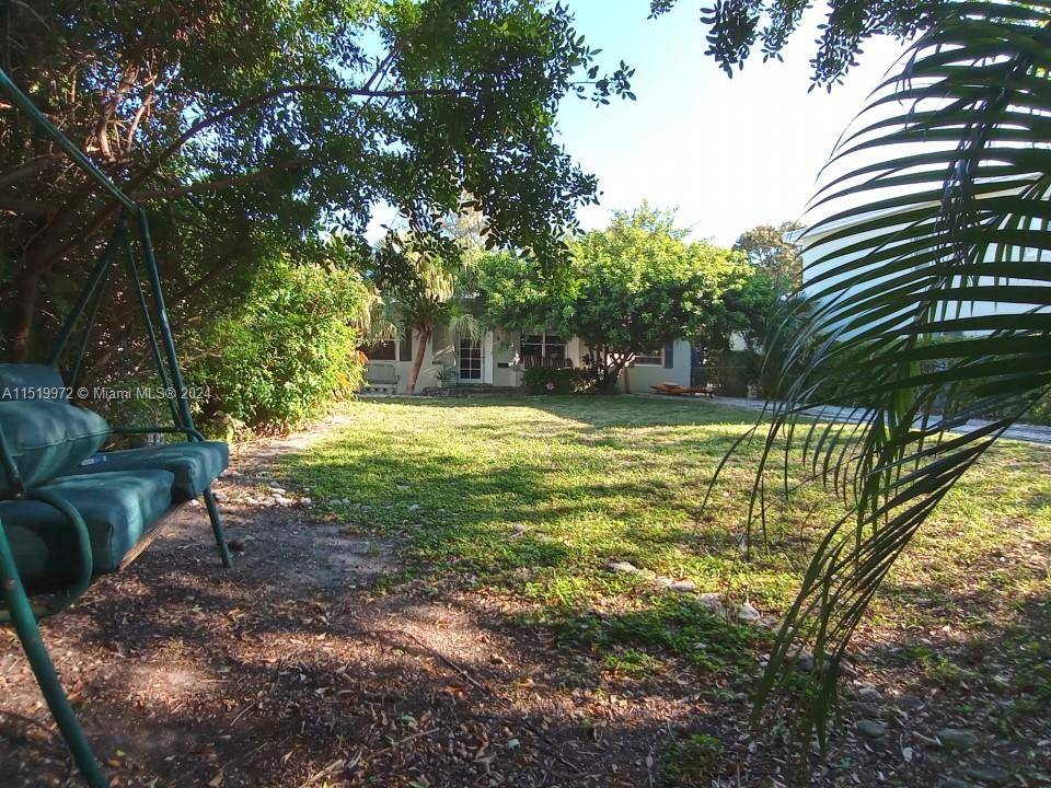 Alluring 1947 Miami Beach home set within the picturesque tree lined park setting of Lake View Miami Beach.