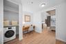 Laundry area featuring washer / dryer, a desk, and light wood-style floors