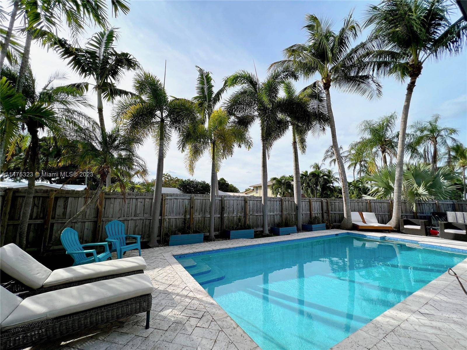 Experience the epitome of tropical luxury living on this pristine corner lot with tropical landscaping, large pool, and freshly updated exterior and interior !