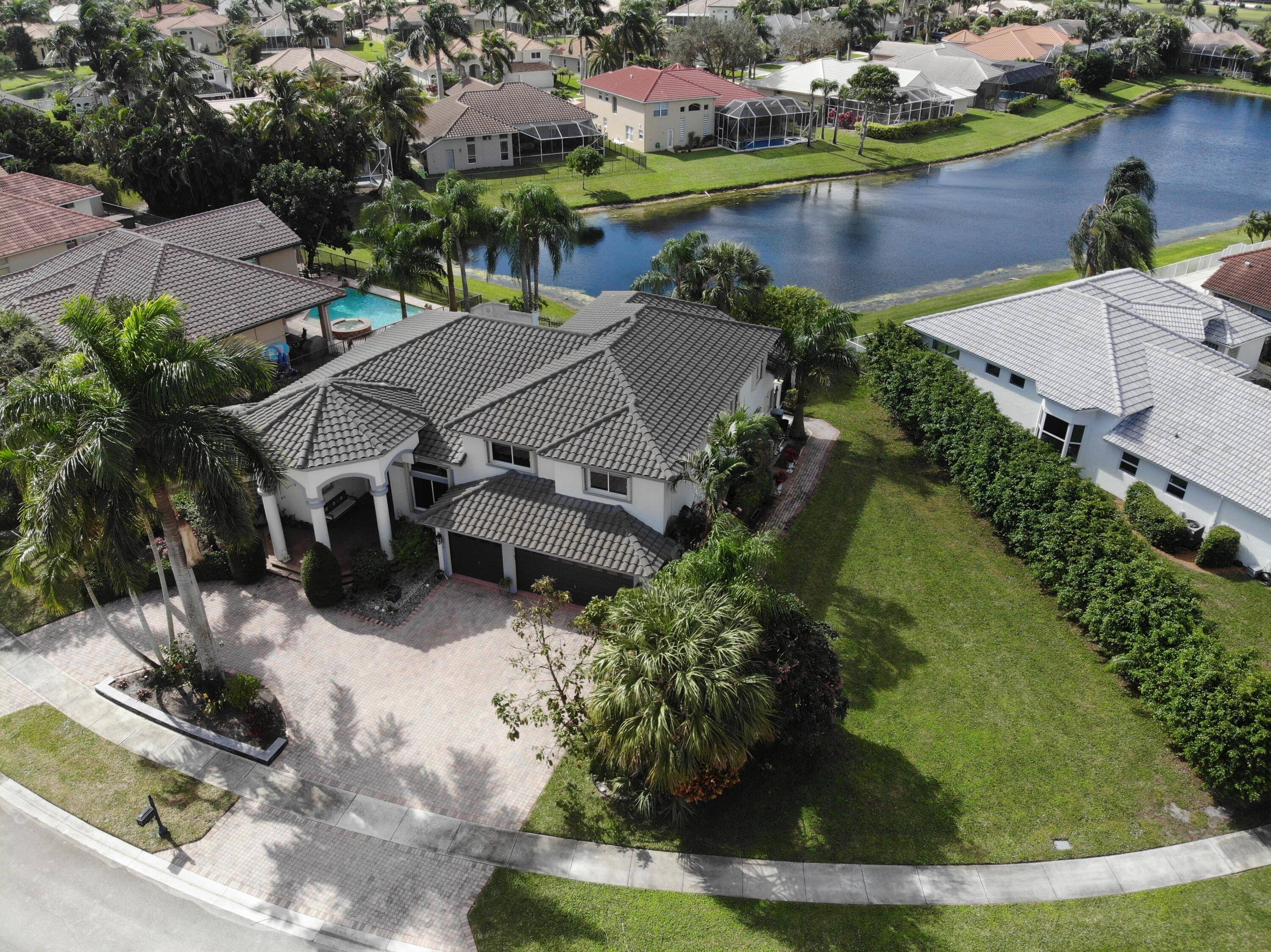 Nestled in the prestigious RESERVE section of Boca Isles South, this Palm Beacher model estate is a true gem, boasting the LARGEST LOT available in the neighborhood.