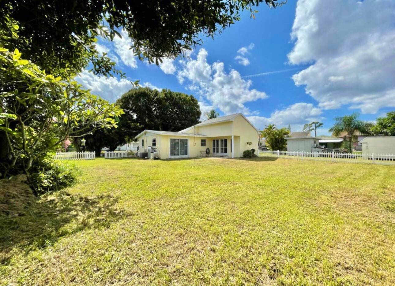 HOME SWEET HOME ! Nestled in Palm Beach Gardens sits this spacious cozy 3 2 cottage on over a third of an acre.