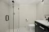 The newly renovated primary bathroom offers a fresh, sophisticated aesthetic with beautifully selected finishes.