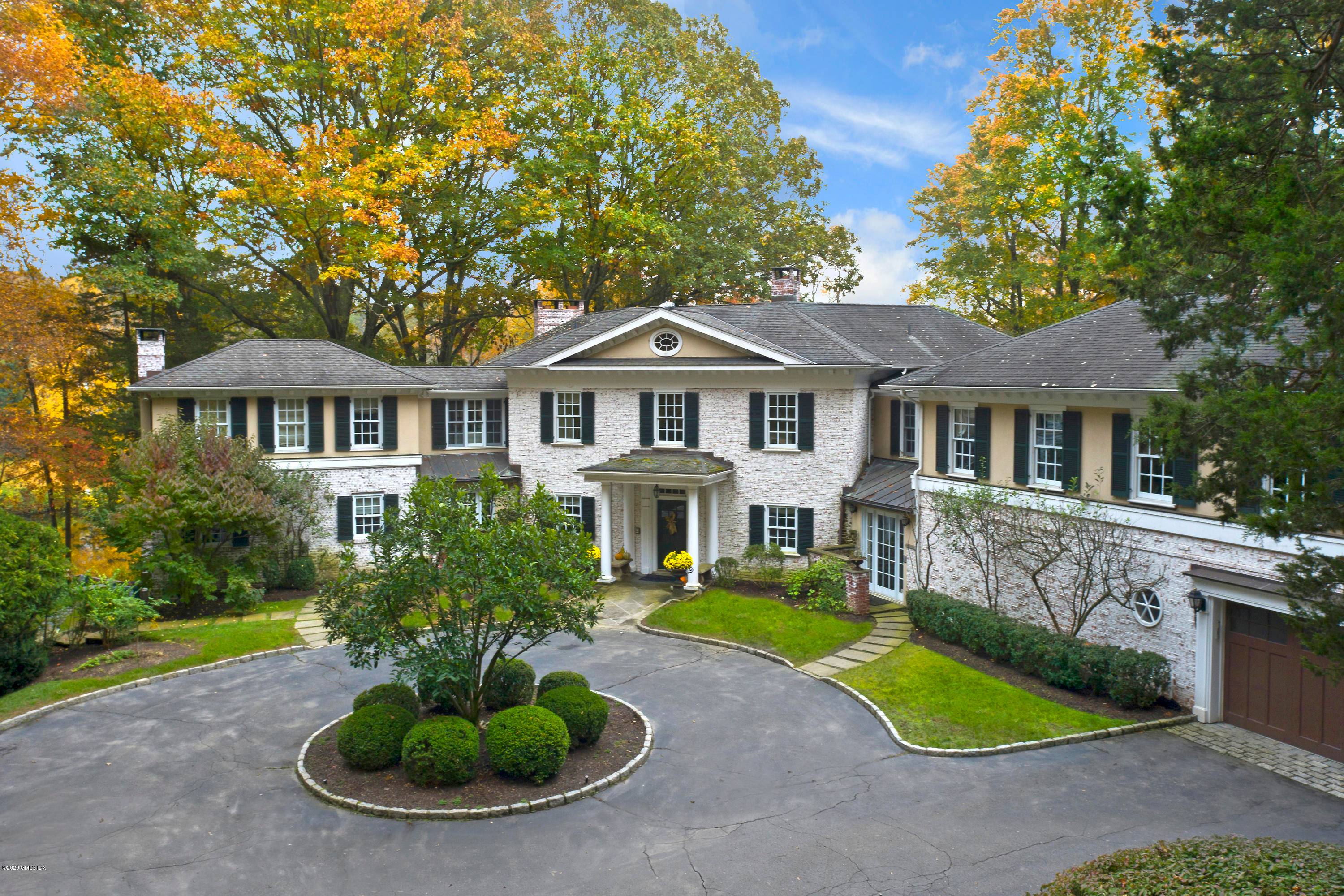 Elegant country estate in a truly magical setting on Collins Pond and the Rippowam River in bucolic New Canaan.