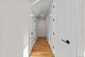 Hall with light wood-style floors and recessed lighting