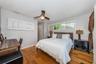 Primary bedroom with vertical acordian blinds