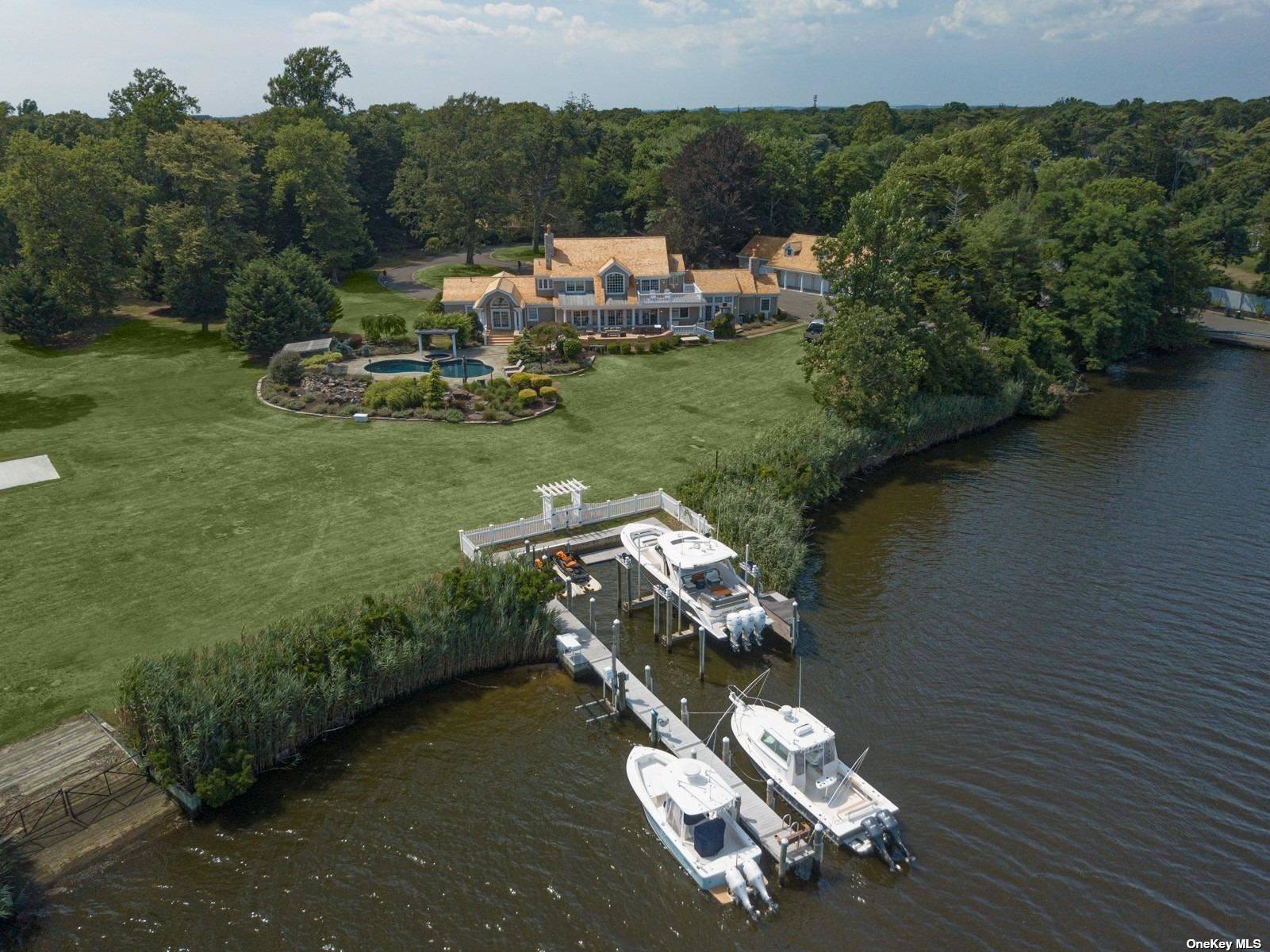 One of a kind cedar shake Hamptons style waterfront estate nestled on 2.