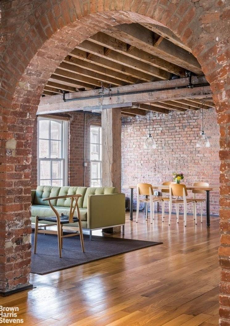 This architecturally stunning two bedroom, two bathroom loft on a prime TriBeCa block features dramatic brick archways, massive columns and rough sawn timber beams.