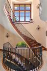 Stairs featuring tile patterned flooring and a high ceiling