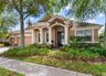 Inviting exterior with mature landscaping and covered entry.