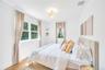 Bedroom with wood finished floors and baseboards