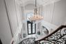 Foyer with french doors, a decorative wall, a chandelier, healthy amount of natural light, and crown molding