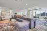 Living room featuring recessed lighting, baseboards, and a raised ceiling