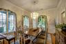 Dining space with a notable chandelier, wood-type flooring, ornamental molding, and a wealth of natural light
