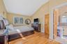 Bedroom with vaulted ceiling and light wood-style flooring