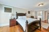 Bedroom with ornamental molding and light wood-type flooring