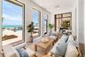 The covered and screened terrace off the formal living as well as the gathering room. What a view of the gorgeous water and the swimming pool!