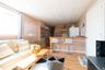 Living room with light hardwood / wood-style floors and a paneled ceiling