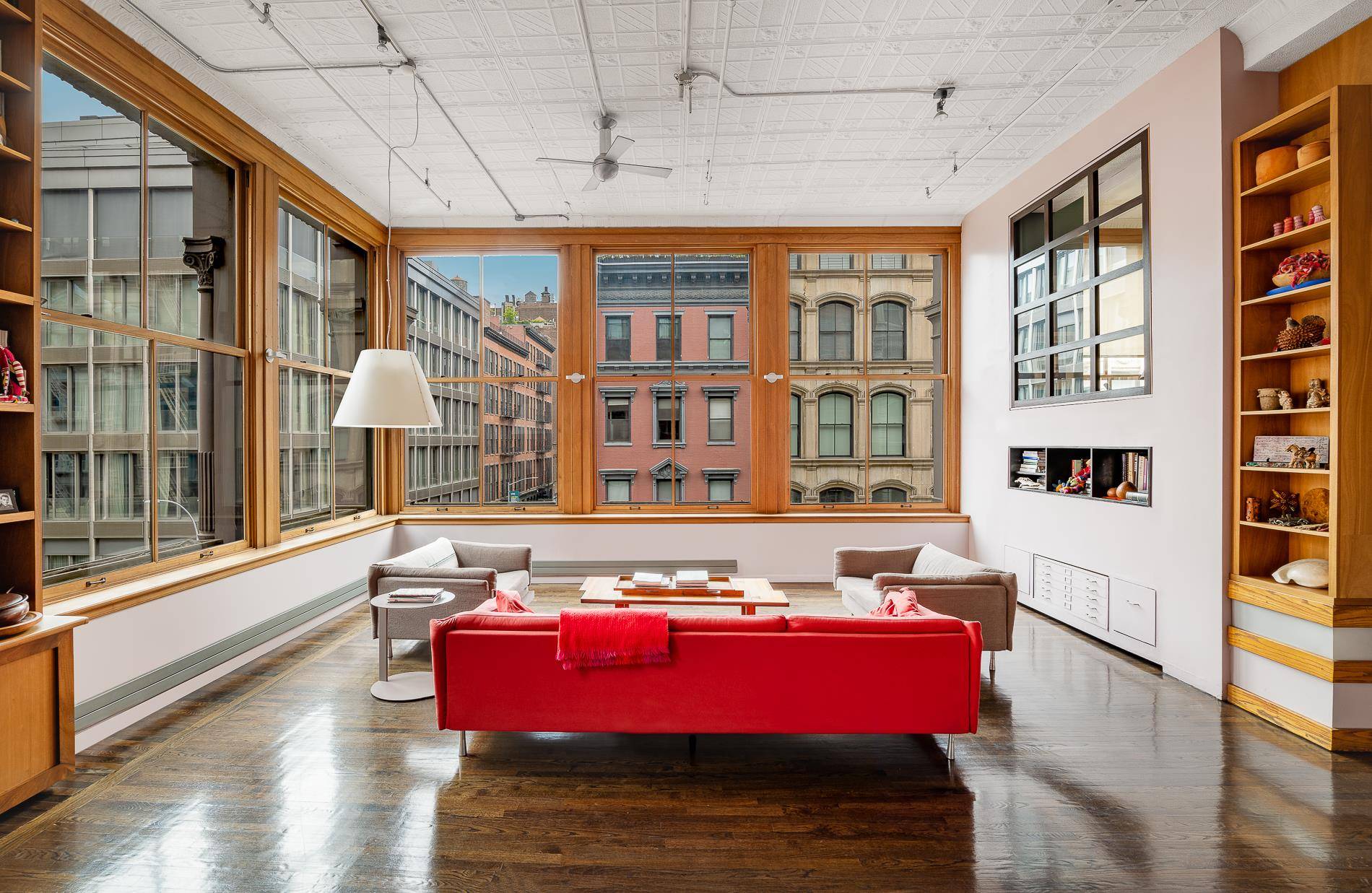 This dramatic corner condominium loft radiates true SoHo character and magnificence with soaring ceilings of over 13 feet and breathtaking volume and scale.