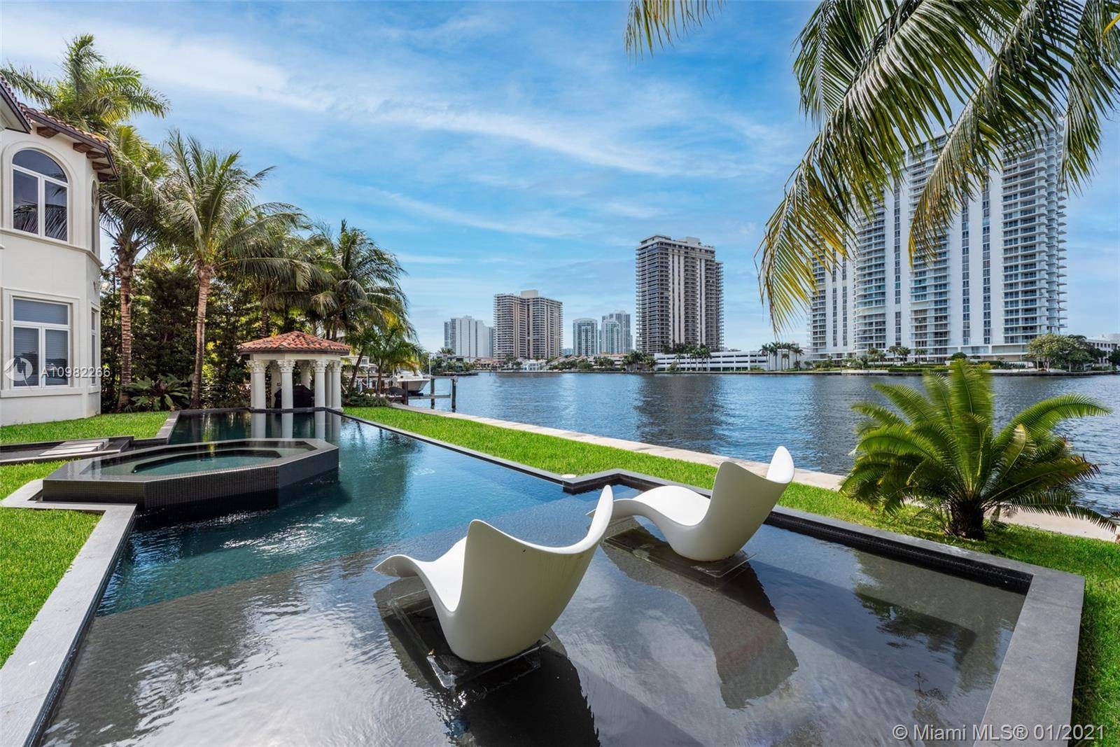 Stunning and impeccably designed waterfront estate by Affiniti Architects with interiors by Steven G, located in one of South Florida s most exclusive gated communities.