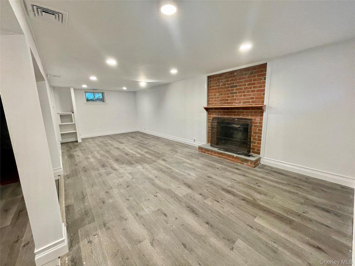 Finished lower level recreation room with fireplace. Laundry room and storage room