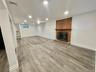 Finished lower level recreation room with fireplace. Laundry room and storage room
