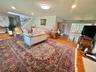 Hardwood flooring throughout, recessed lighting, skylight, and an open stairway with wrought iron balusters