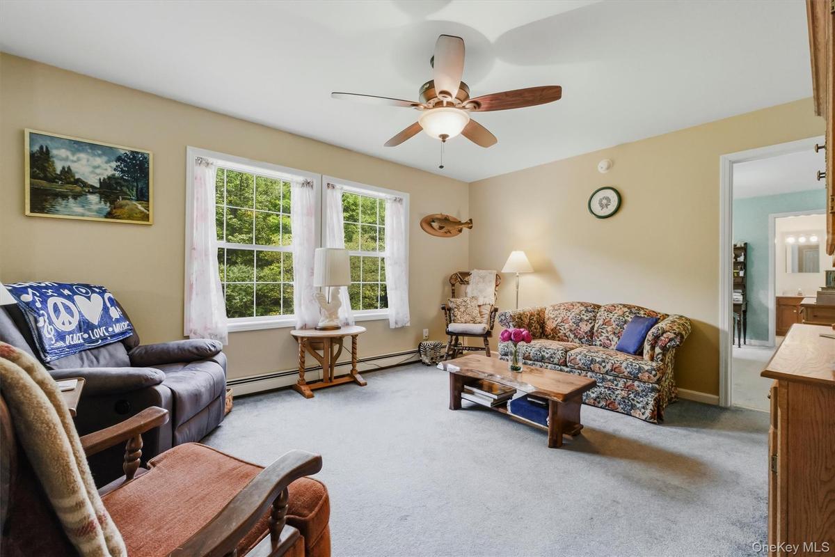 Just beyond the living room is the primary bedroom and en suite bath