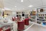Living area featuring wainscoting, built in shelves, a paneled ceiling, and recessed lighting
