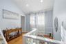 Corridor with lofted ceiling, light wood-style flooring, an upstairs landing, and recessed lighting