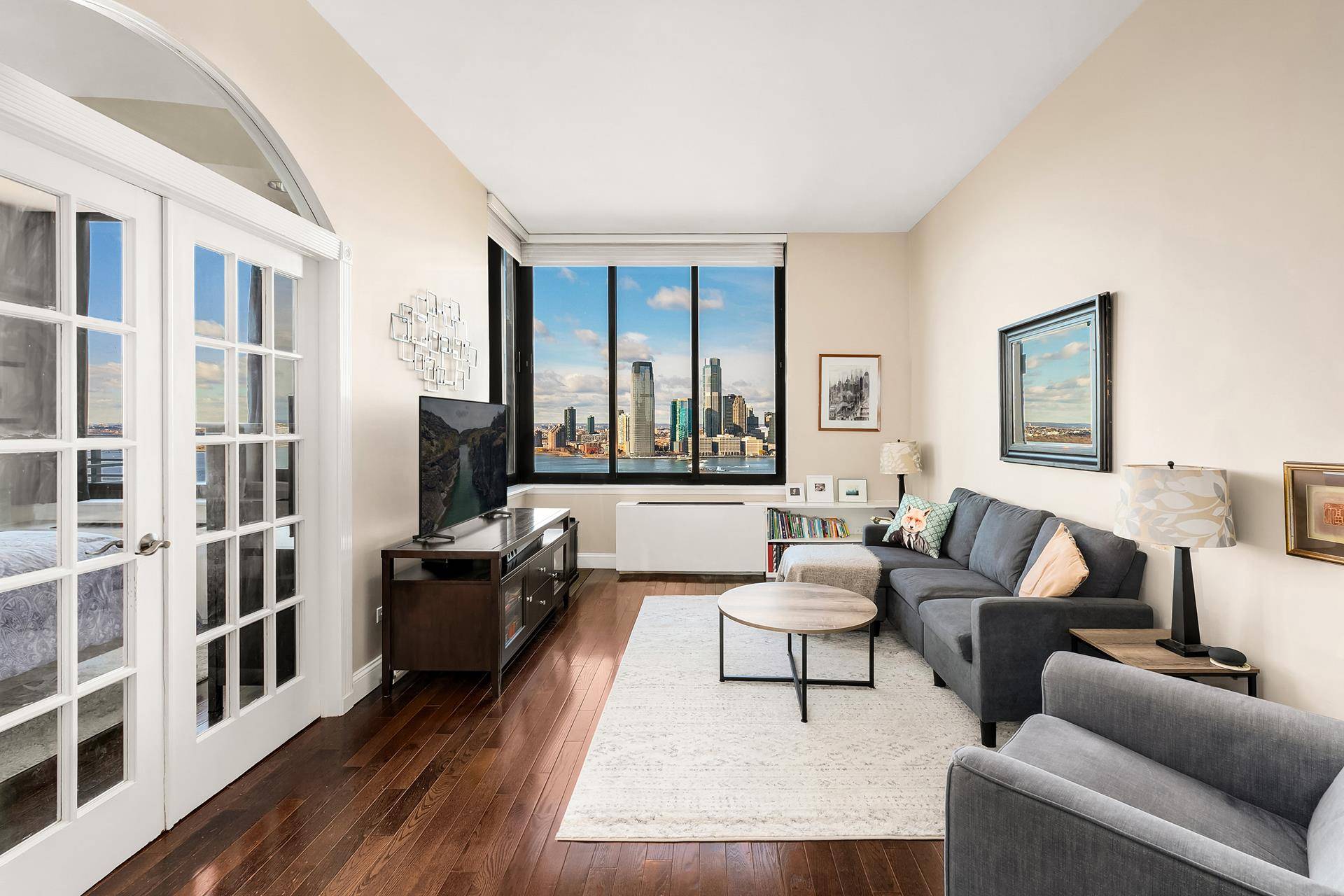 TENANT IN PLACE. Enjoy spectacular sunsets and inspirational Statue of Liberty and Ellis Island views from this high floor one bedroom condominium overlooking New York Harbor.