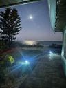 The moon casts a silver glow on the waves, creating a shimmering oath.