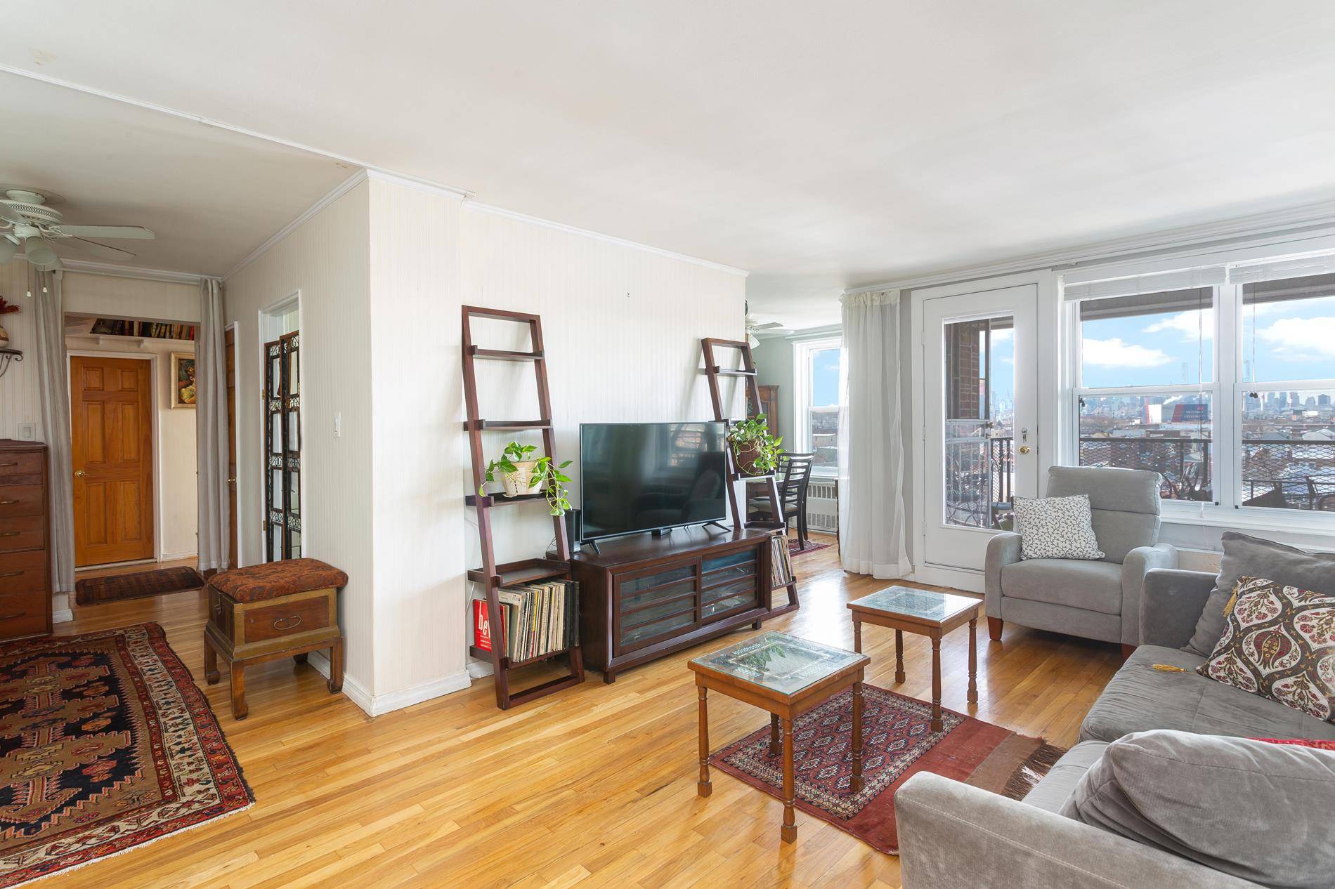 This charming and bright two bedroom, two bathroom co op home in Woodside has an updated kitchen with stainless appliances and a dining alcove with views of the Manhattan skyline.