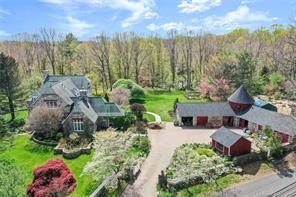 Behind the electric gates sits this most Picturesque and Charming stone colonial on over 2 majestic acres.