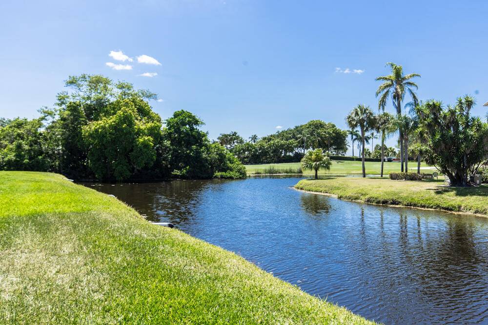 Penthouse corner unit with panoramic water golf views of the BallenIsles golf course.