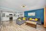 Living area with light wood finished floors and ceiling fan