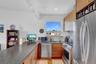 Kitchen featuring appliances with stainless steel finishes, modern cabinets, a peninsula, and a sink
