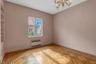 Spare room featuring radiator, a textured ceiling, and a chandelier