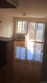 Unfurnished room featuring a wall mounted air conditioner and wood finished floors