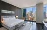 Bedroom with expansive windows and wood-type flooring