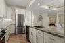 Outfitted with premium stainless steel appliances that complement the kitchen’s elevated custom design.